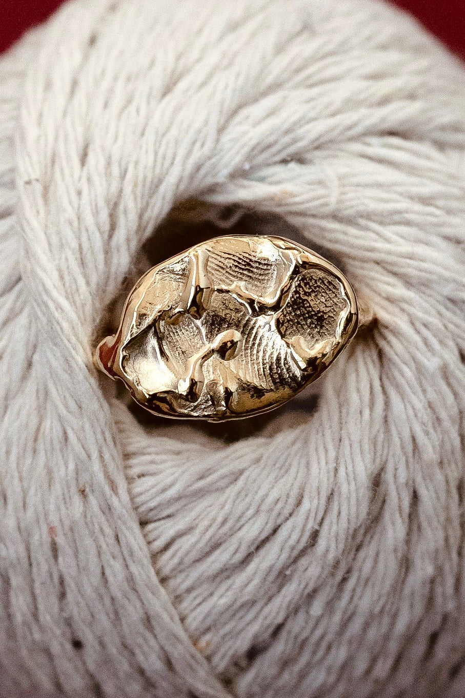 A gold fingerprint impression ring resting on a child’s hand, handcrafted in 18ct yellow gold, symbolizing love, connection, and timeless memories.